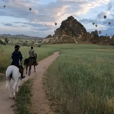sunrise under balloons horse ride cappadocia