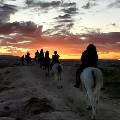 sunrise under balloons horse ride cappadocia